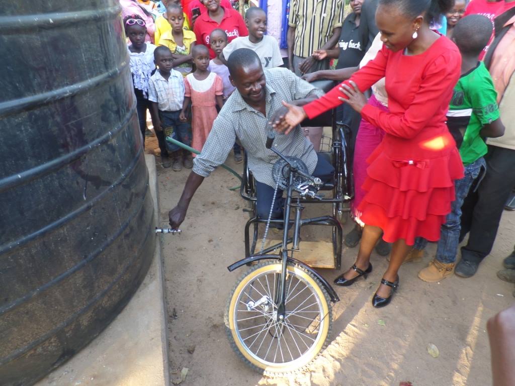 Handover ceremony for Richard Makula wheelchair and water tank